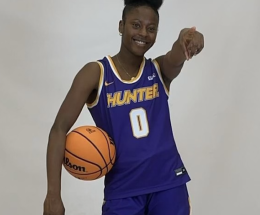 Alexa Charles poses for the camera, basketball in hand.