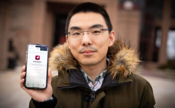 Man holds phone showing new app GoKnights