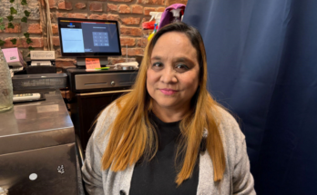 Owner of Little Myanmar, Thyar Kyar, photographed in her small point-of-sales area.