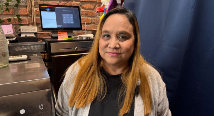 Owner of Little Myanmar, Thyar Kyar, photographed in her small point-of-sales area.