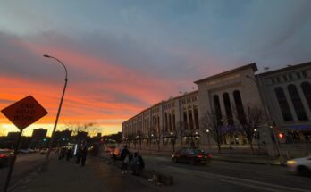 Sunset at Yankee Stadium as people wait for the bus.