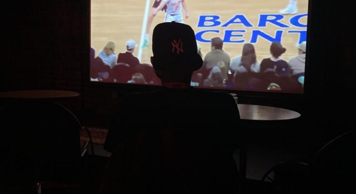 A Liberty fan watching the game at the bar Singers.