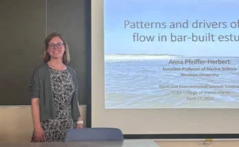Anna Pfeiffer-Herbert stands in front of the whiteboard before her presentation.